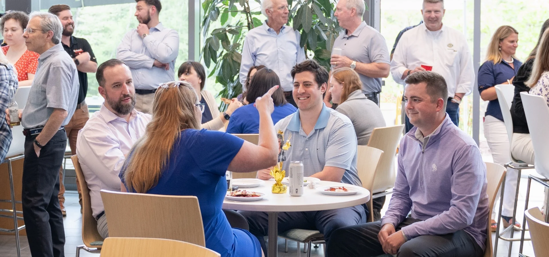 ODG employees sitting at a table and talking during a retirement party