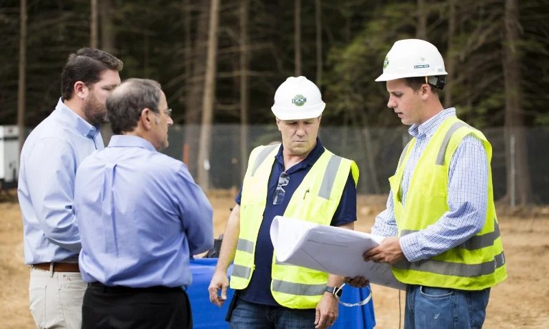 project managers in the field at a construction site