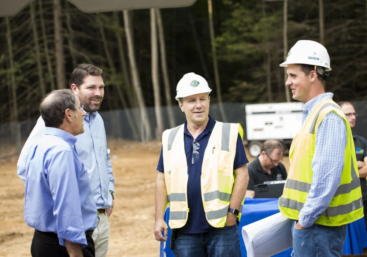 group of people talking at a construction site